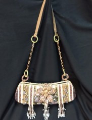 A beautiful sling bag on a black color cloth as a background